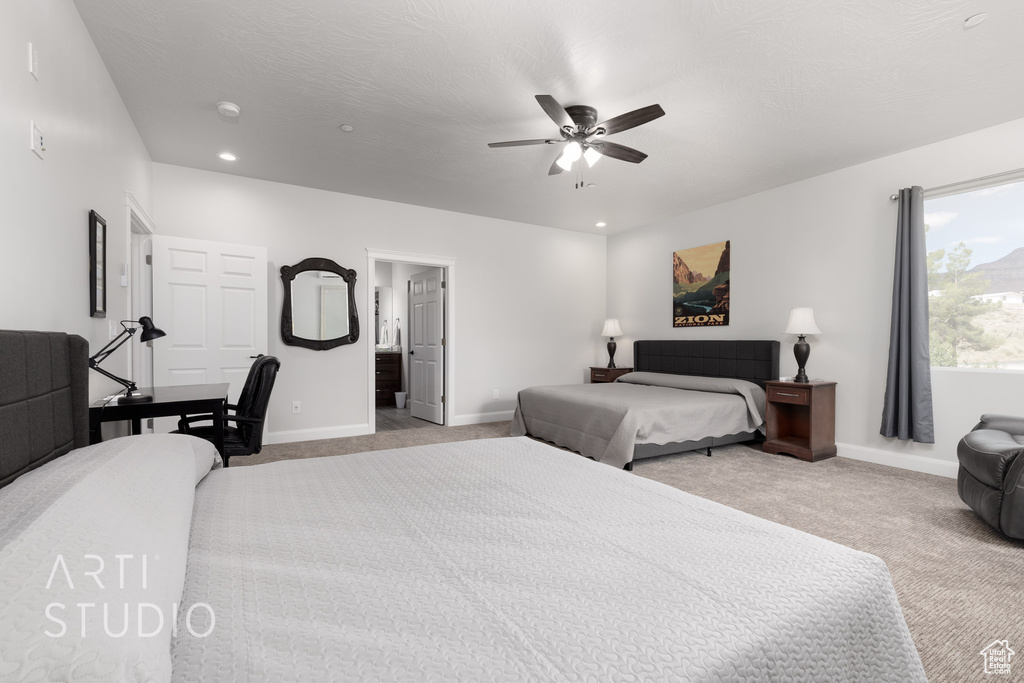 Carpeted bedroom featuring ceiling fan