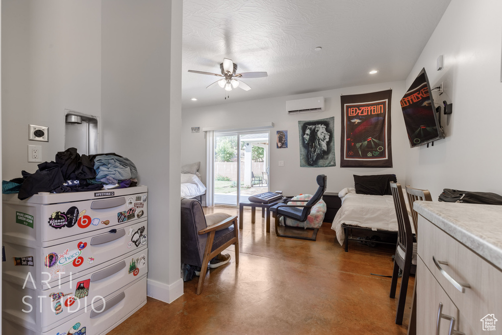 Bedroom with ceiling fan, concrete floors, access to outside, and a wall unit AC