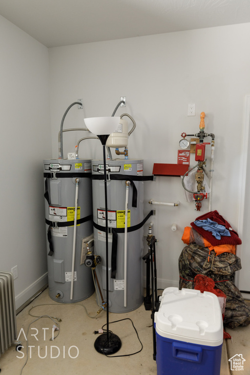 Utility room featuring secured water heater and radiator