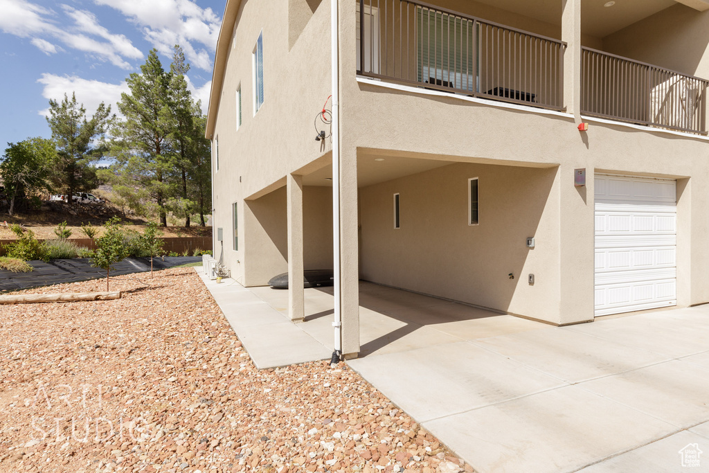 View of home's exterior with a balcony and a garage