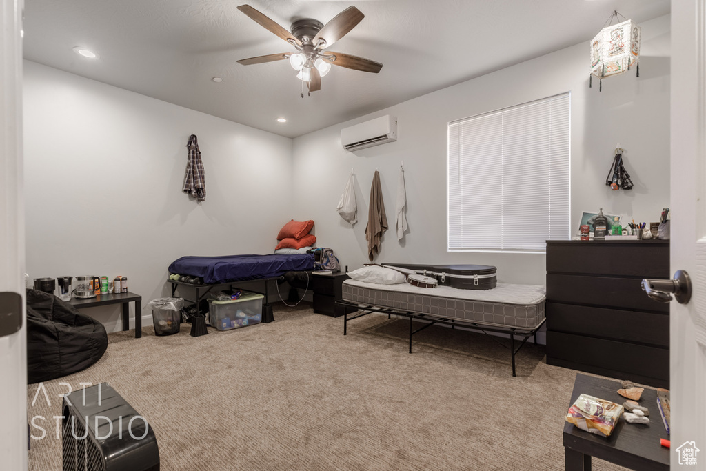 Bedroom with ceiling fan, carpet flooring, and an AC wall unit