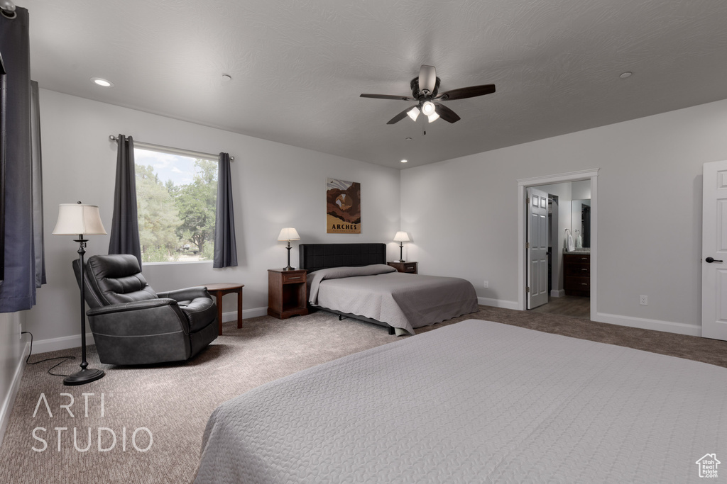 Carpeted bedroom with ceiling fan and connected bathroom