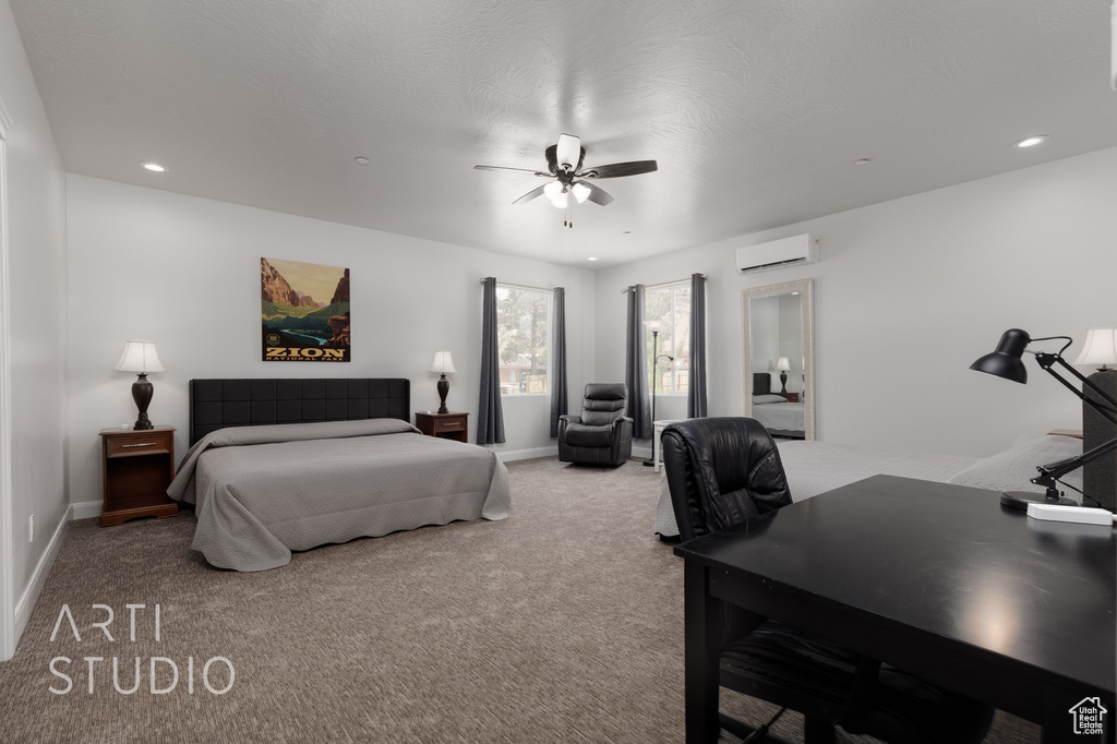 Carpeted bedroom featuring ceiling fan and an AC wall unit