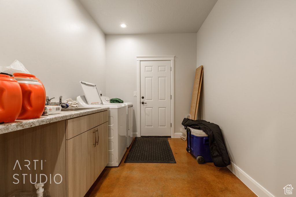 Clothes washing area featuring separate washer and dryer