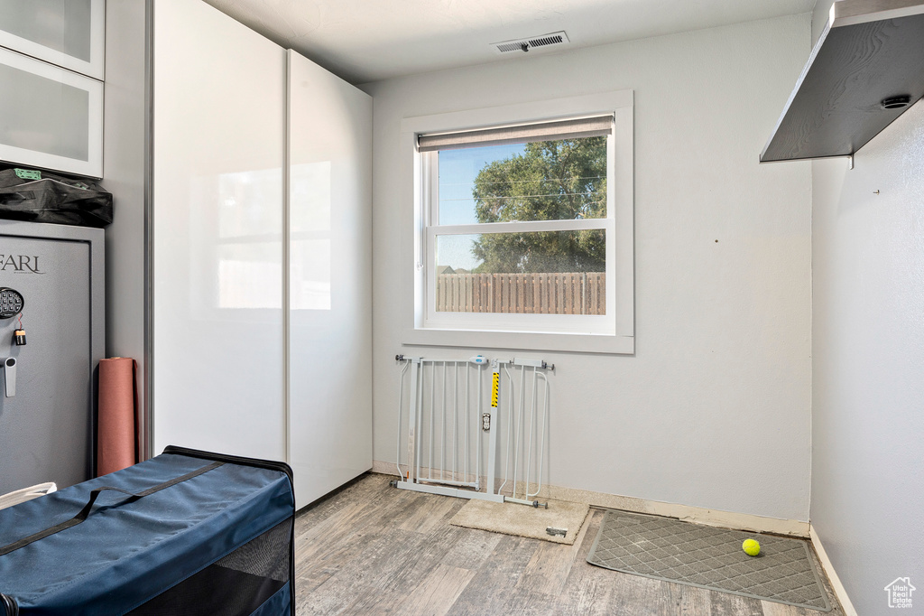 Laundry room featuring radiator heating unit and light wood-type flooring