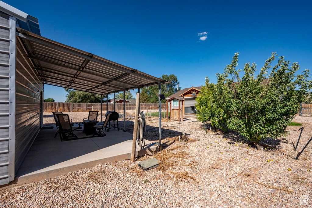 View of yard featuring a storage shed and a patio area