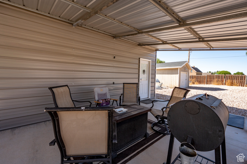 View of patio featuring grilling area and a shed