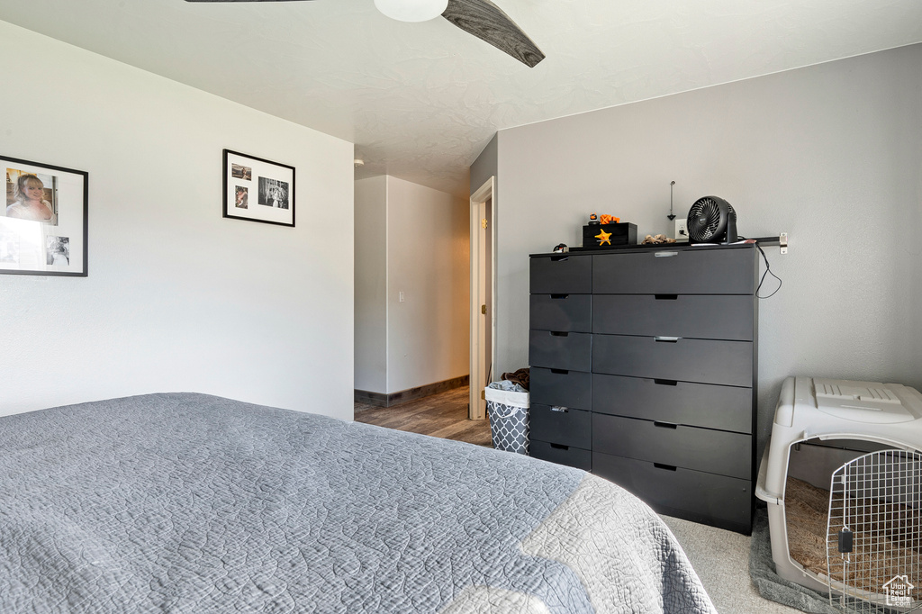 Bedroom with ceiling fan and hardwood / wood-style flooring