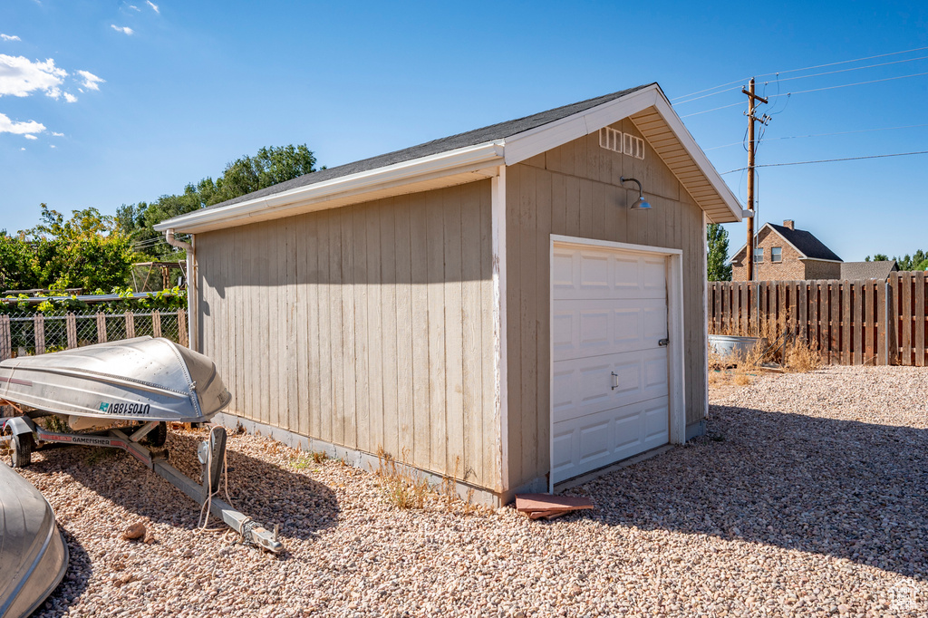 View of outbuilding featuring a garage