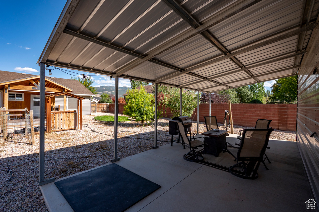 View of patio with a grill