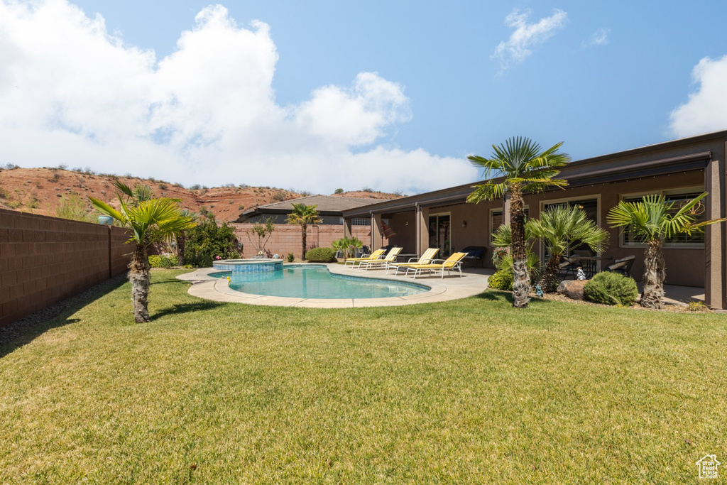 View of pool featuring a yard and a patio