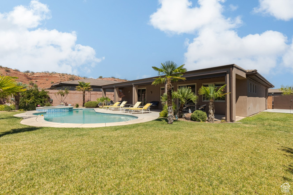 View of pool with a yard and a patio