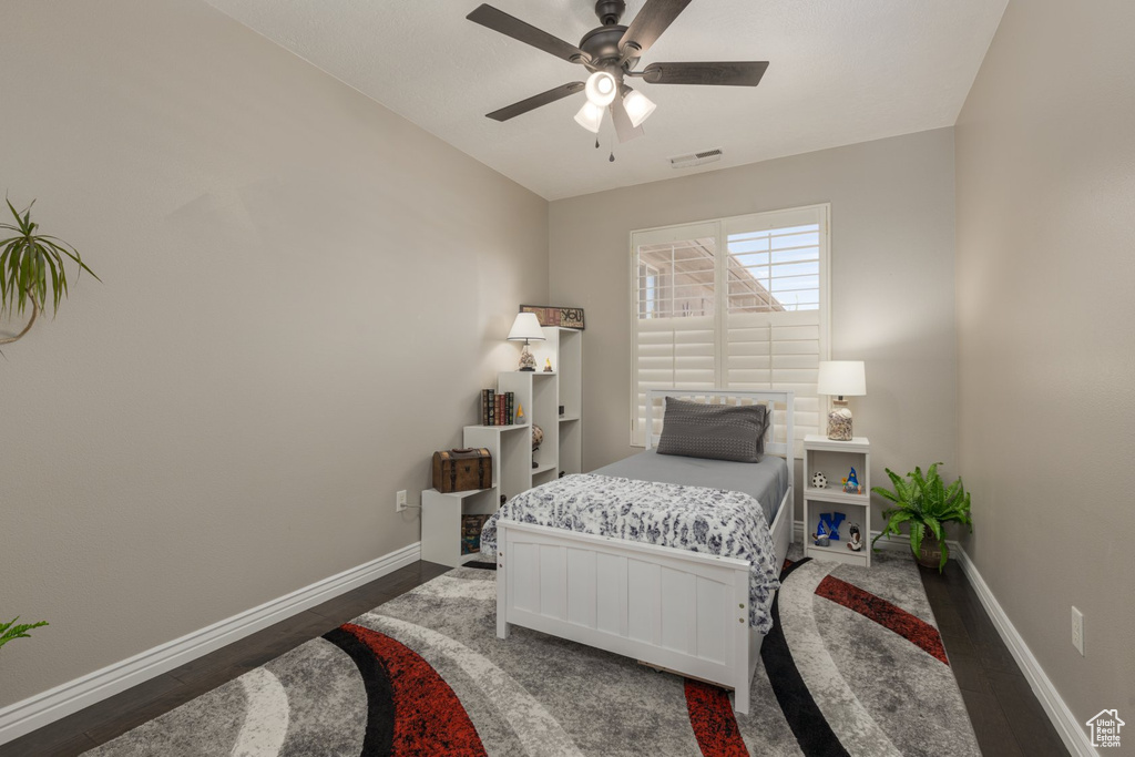 Bedroom featuring dark wood-type flooring and ceiling fan