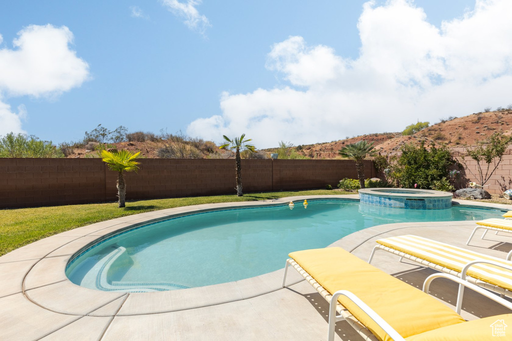 View of pool with an in ground hot tub