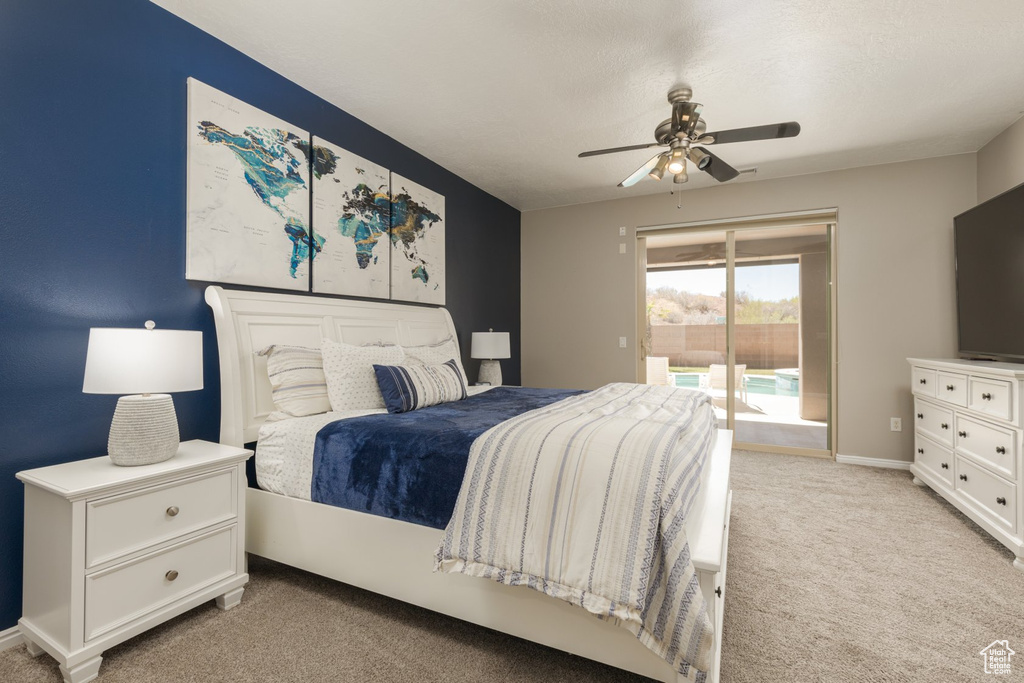 Carpeted bedroom featuring ceiling fan and access to outside