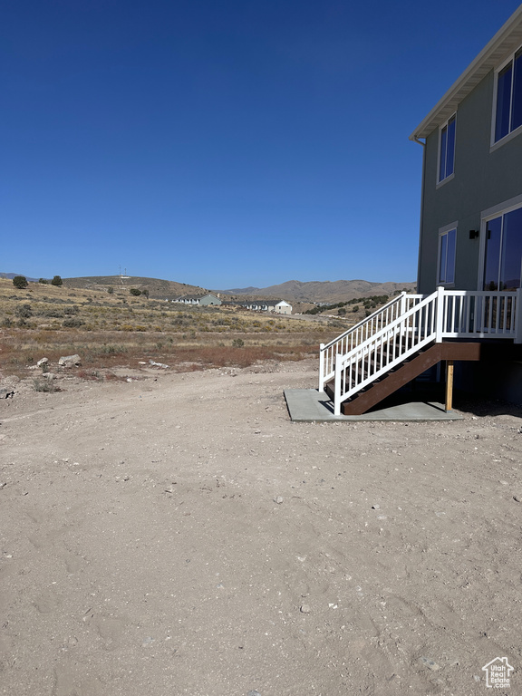 View of yard featuring a deck with mountain view