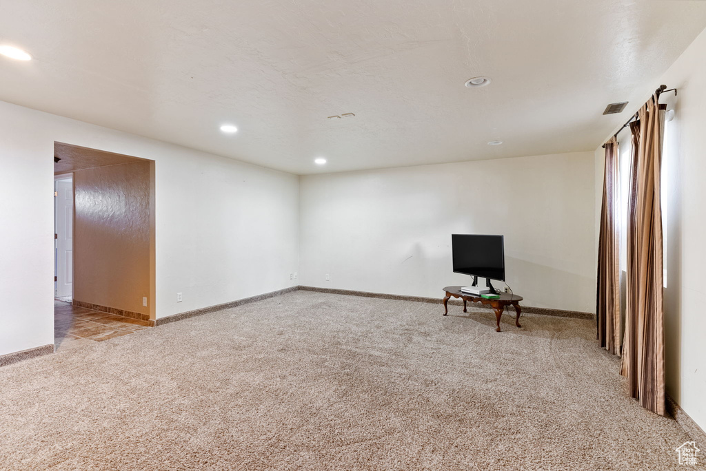 Unfurnished room featuring light carpet