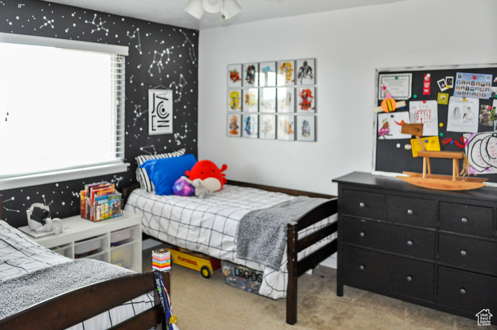 Bedroom with light carpet and ceiling fan