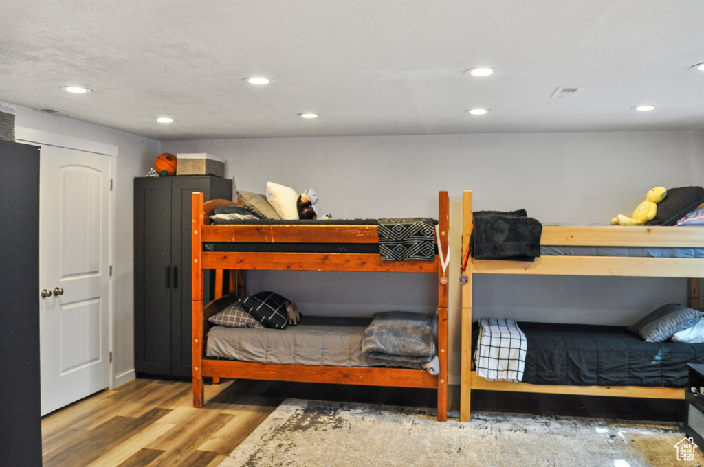 Bedroom with hardwood / wood-style flooring