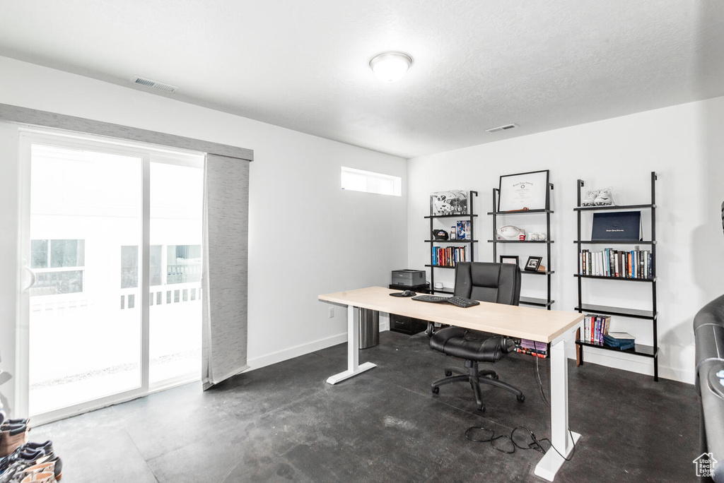 Office space featuring a textured ceiling