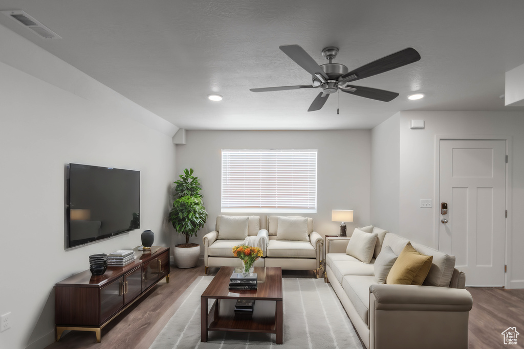 Living room with ceiling fan and light hardwood / wood-style floors