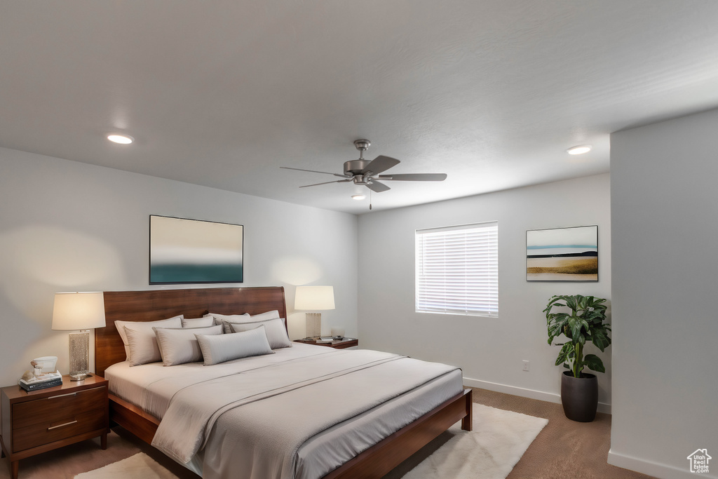 Carpeted bedroom featuring ceiling fan