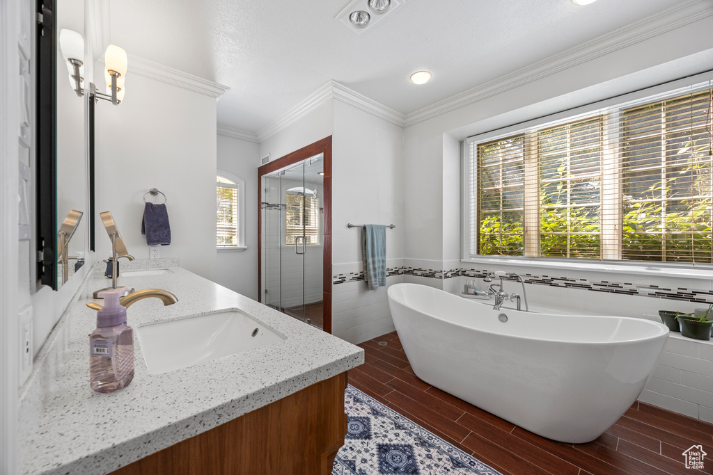 Bathroom featuring vanity, tile walls, hardwood / wood-style flooring, and a washtub