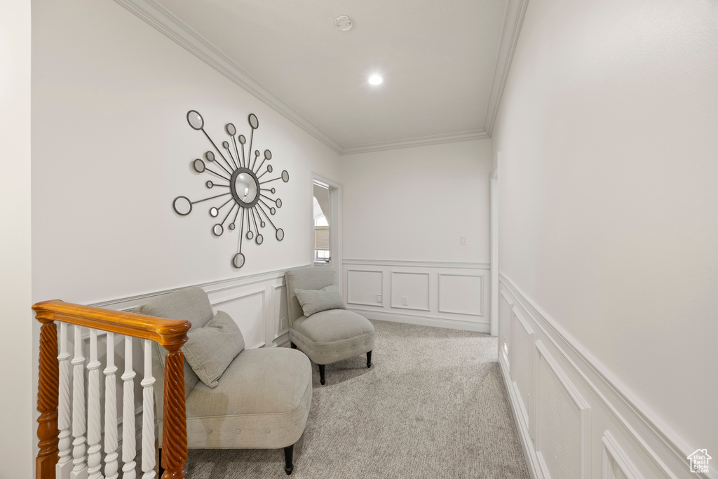 Living area with light colored carpet and crown molding