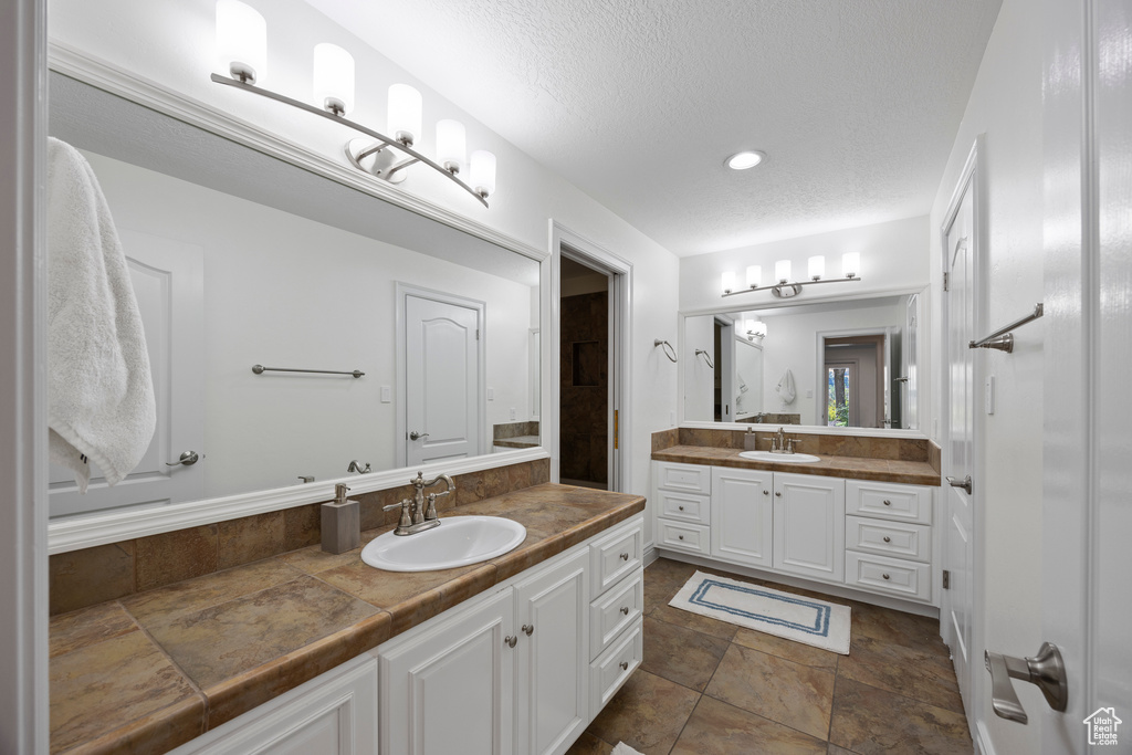 Bathroom with vanity and a textured ceiling