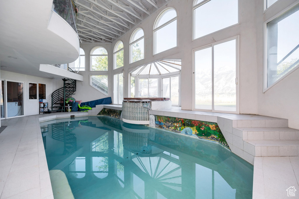 View of swimming pool featuring a hot tub