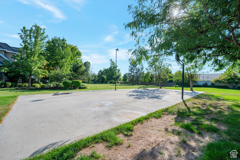 View of basketball court featuring a yard