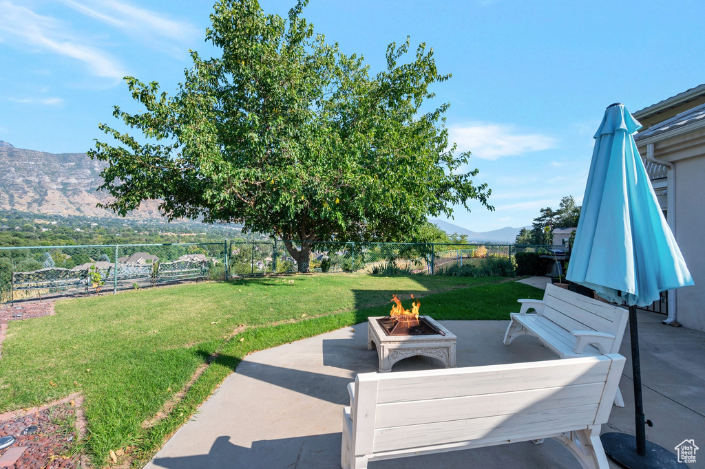 View of patio featuring a fire pit and a mountain view