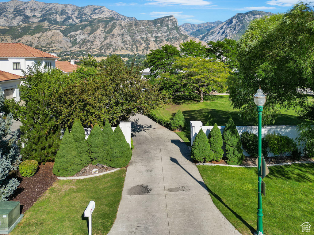 View of property\\\\\\\'s community featuring a yard and a mountain view