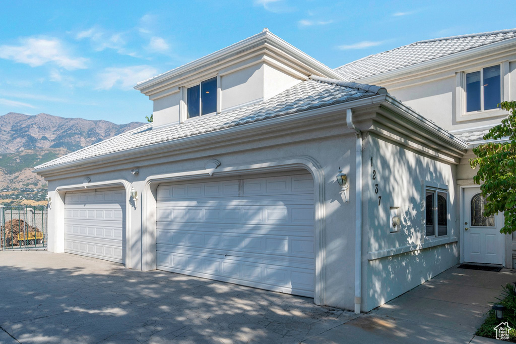 Exterior space with a garage and a mountain view