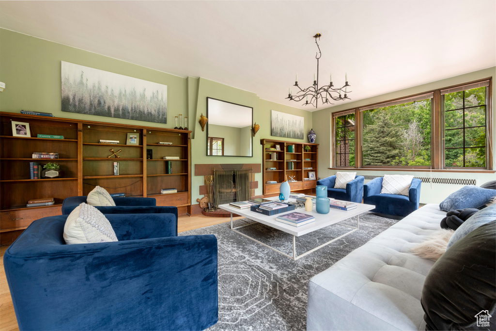 Living area with wood finished floors and a chandelier