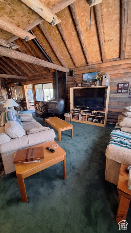 Carpeted living room with a wood stove and vaulted ceiling with beams