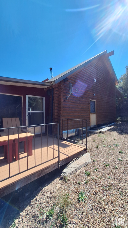 View of side of home featuring a deck