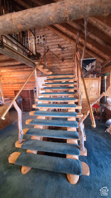 Interior space with carpet flooring and high vaulted ceiling