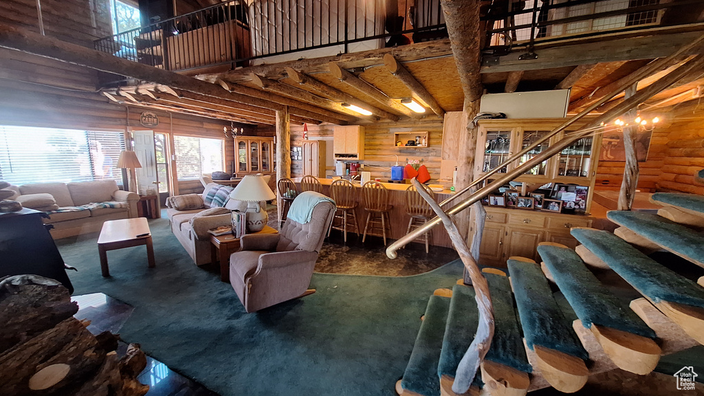 Living room featuring log walls and a towering ceiling