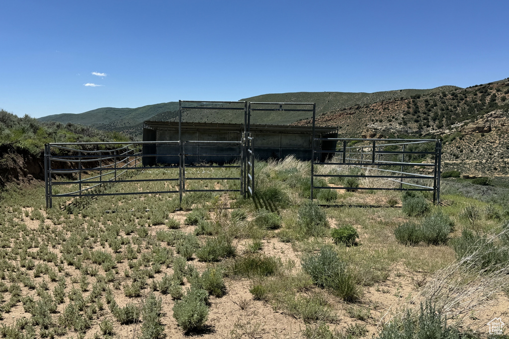 View of yard featuring a rural view and a mountain view