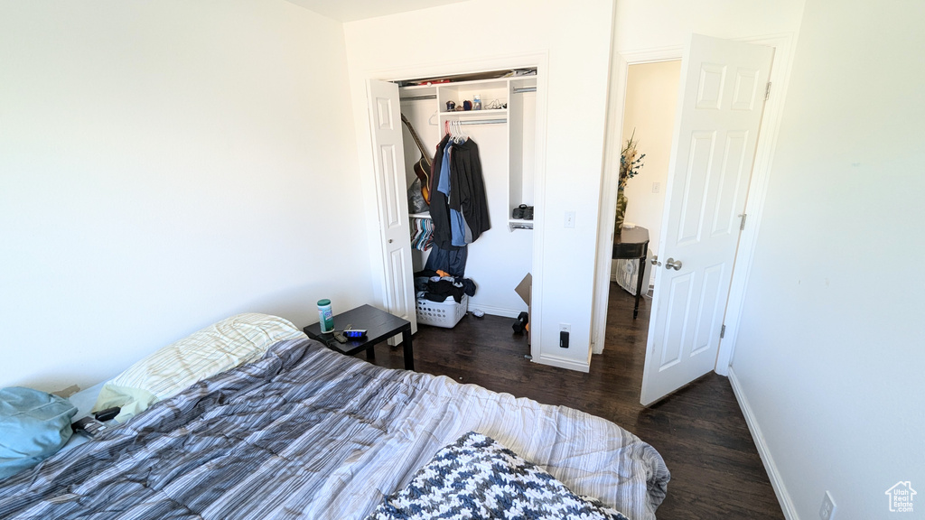 Bedroom featuring a closet and dark hardwood / wood-style flooring