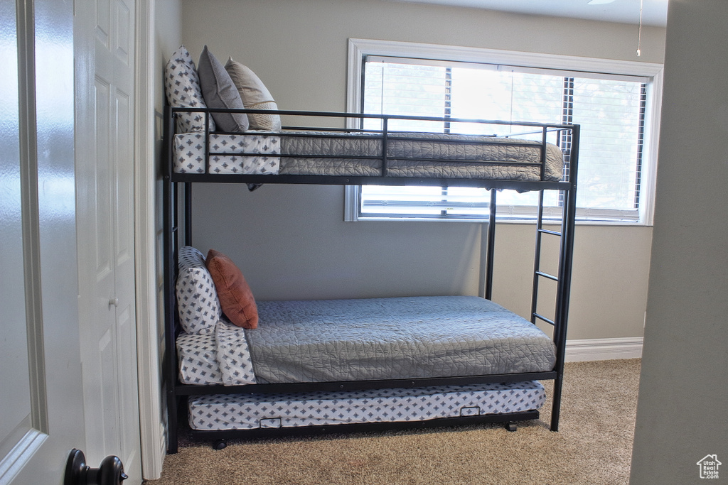 Bedroom featuring carpet and a closet