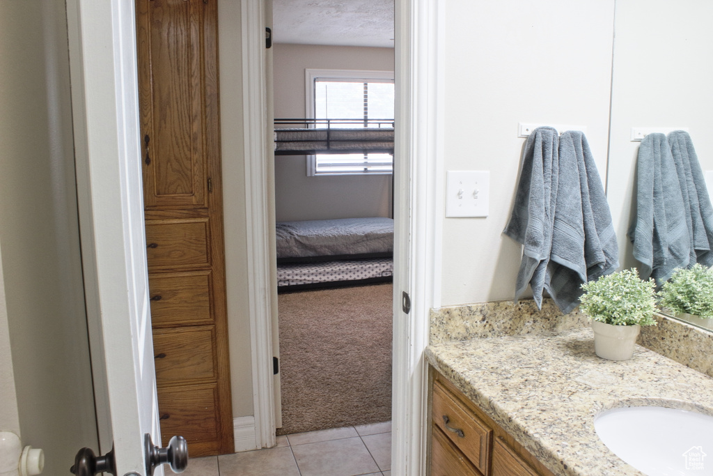 Bathroom featuring vanity and tile patterned floors