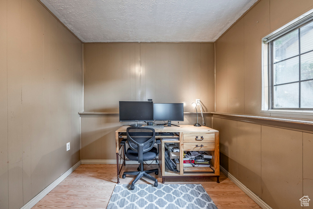 Office featuring a textured ceiling and light hardwood / wood-style floors