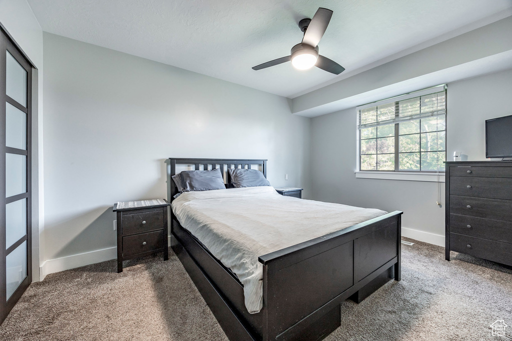 Bedroom featuring ceiling fan and light carpet