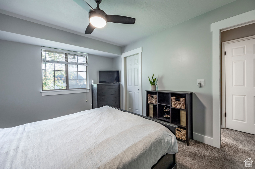 Bedroom featuring ceiling fan and carpet floors