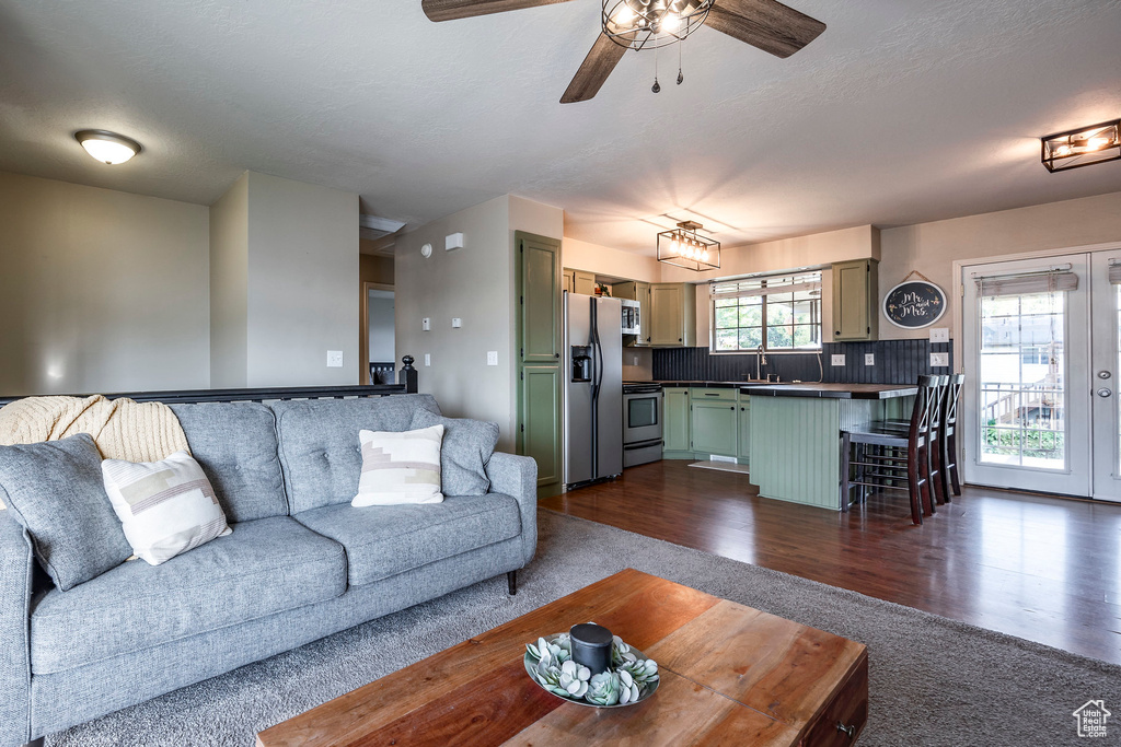 Living room featuring french doors, sink, ceiling fan, and dark hardwood / wood-style floors