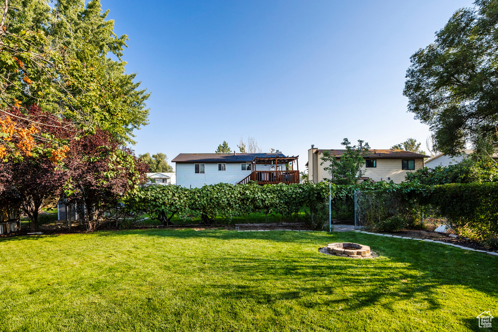 View of yard with an outdoor fire pit