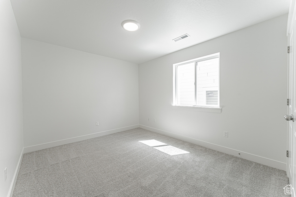 Carpeted empty room with baseboards