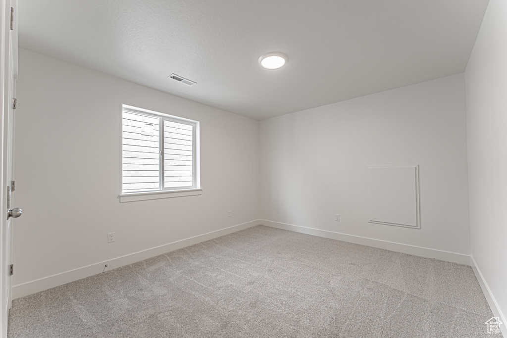 Spare room with baseboards and carpet